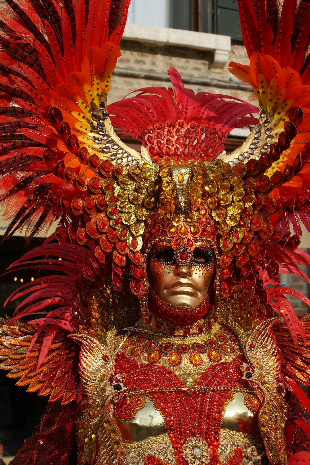 red and gold-colored human statue