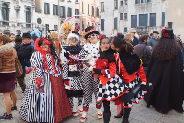 A diverse group of people wearing stylish outfits in a vibrant outdoor setting.