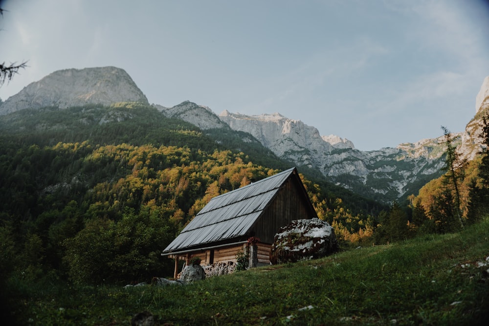 brown wooden house near mountain during daytime