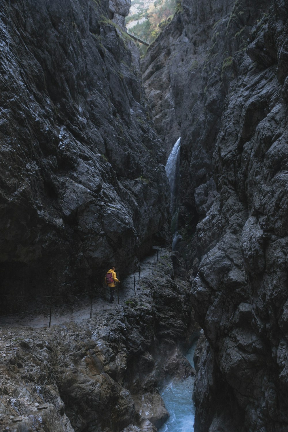 person standing near waterfalls