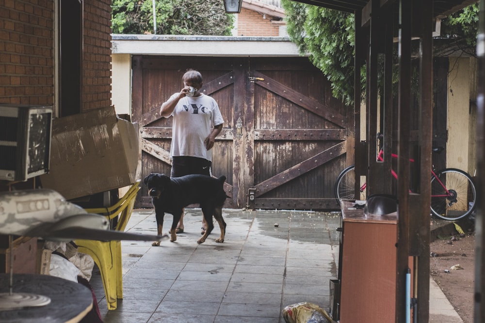 man standing next to dog