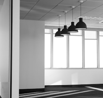 four black pendant lamps in room