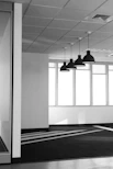 Contemporary office space with minimalist desks and large windows.