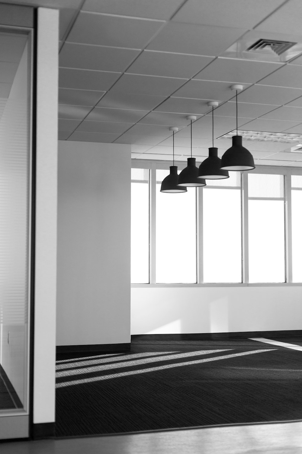 four black pendant lamps in room