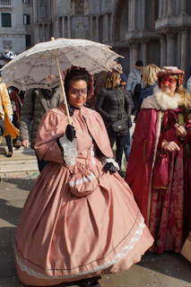 Close-up of historically accurate costumes laid out, showcasing intricate embroidery and period fabrics.
