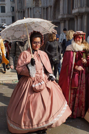 Close-up of historically accurate costumes laid out, showcasing intricate embroidery and period fabrics.