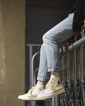 person sitting on gray gate