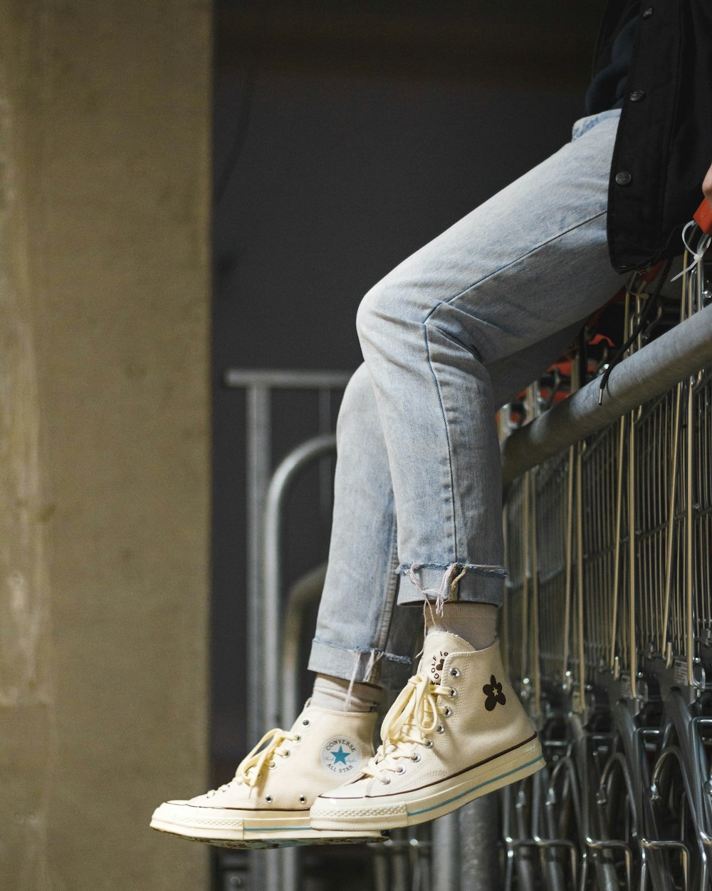 person sitting on gray gate