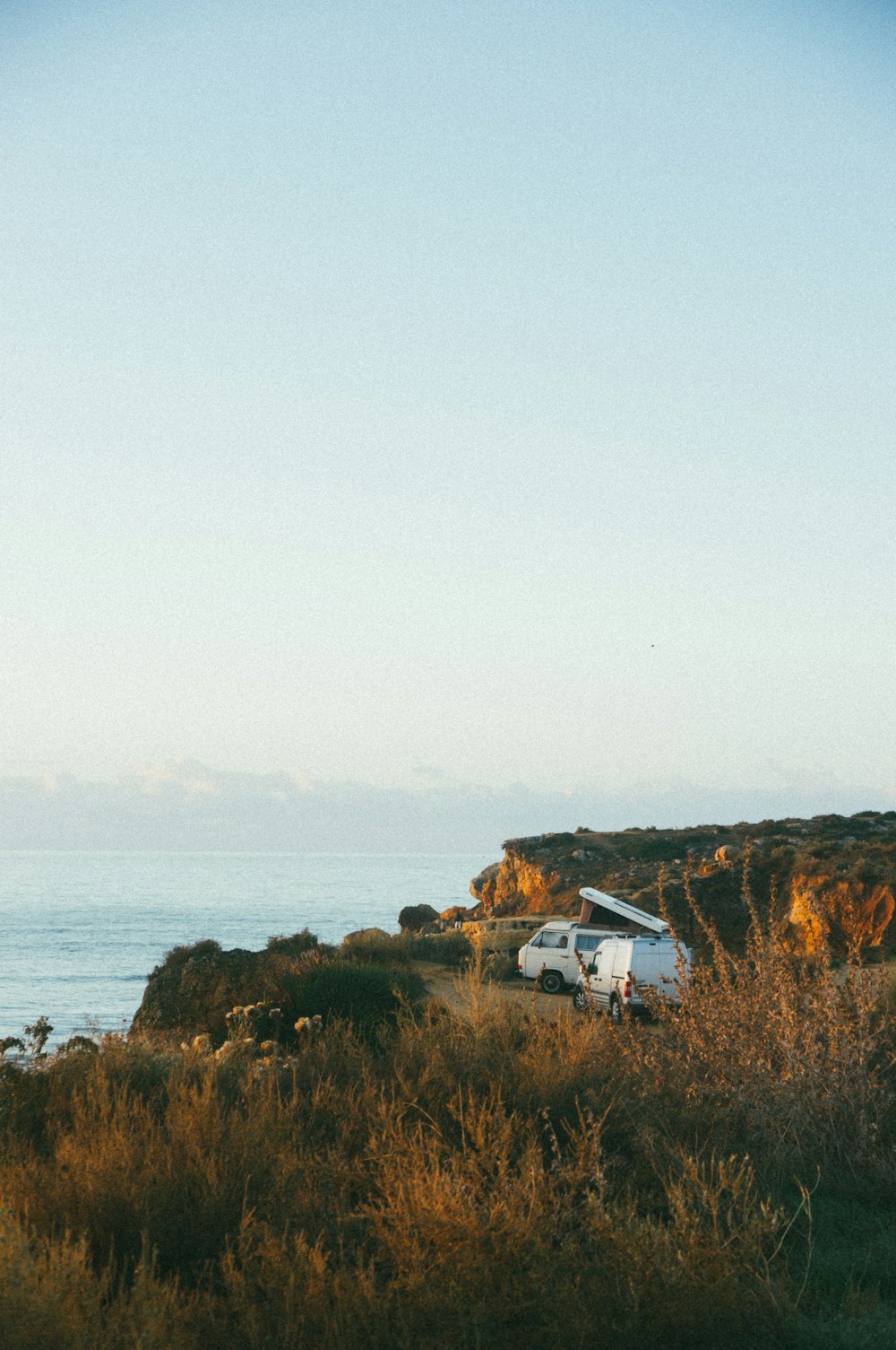 white van near cliff during daytime