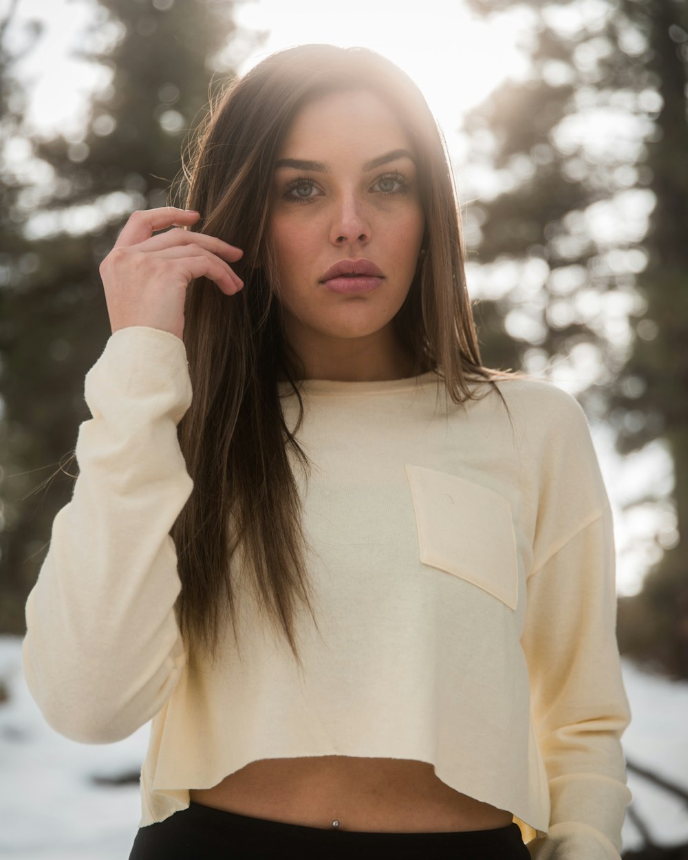 shallow focus photo of woman in white crew-neck long-sleeved crop top