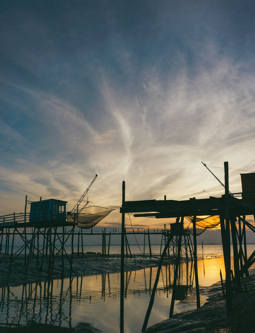 wooden stand beside body of water