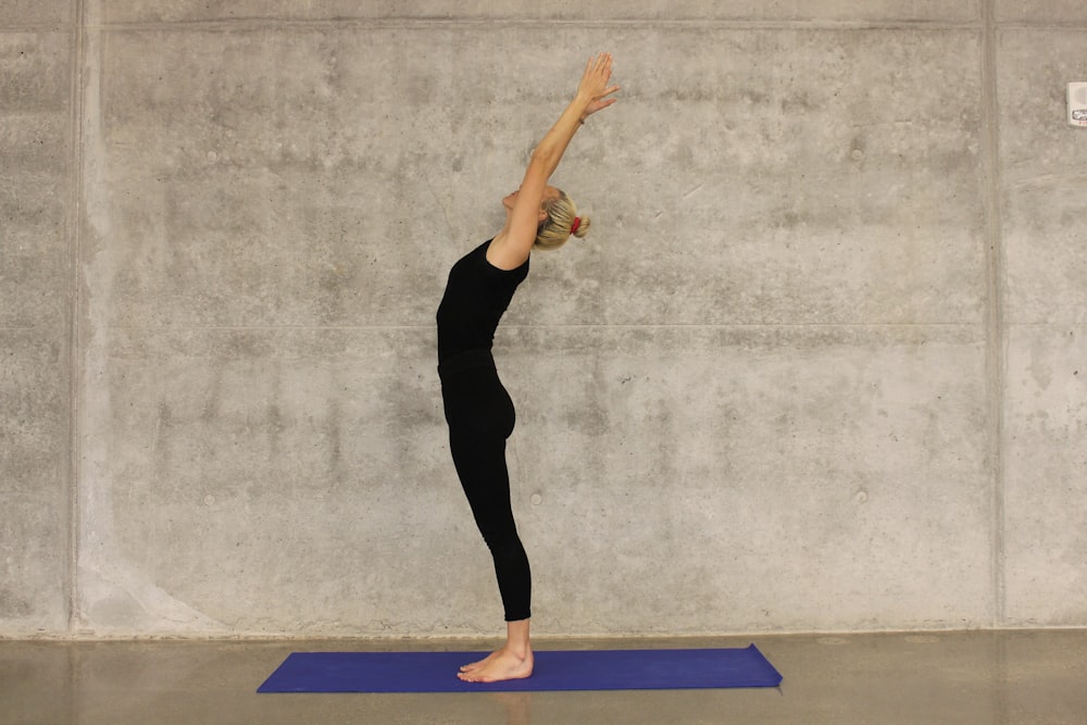 woman doing yoga on yoga mat