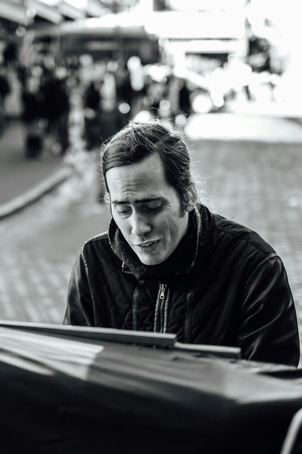grayscale photography of man playing piano