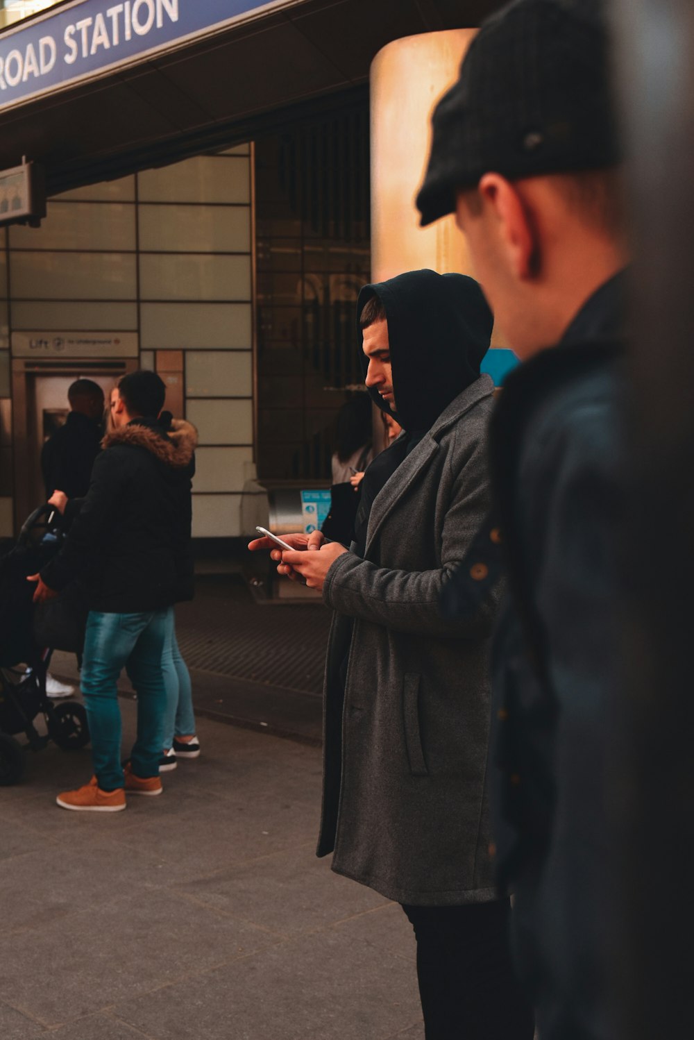 man using phone while standing