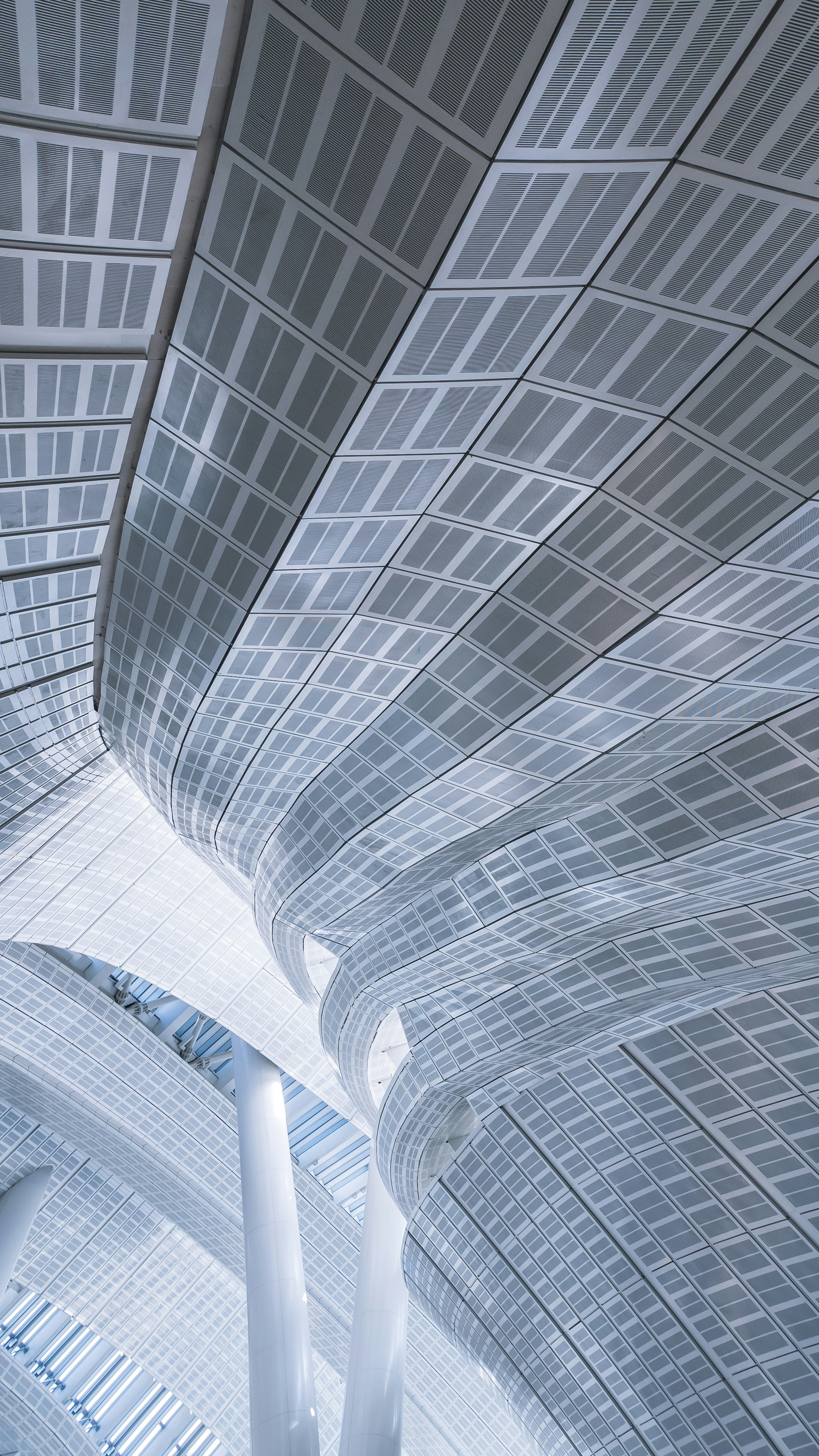 the ceiling of a large building with a clock on it
