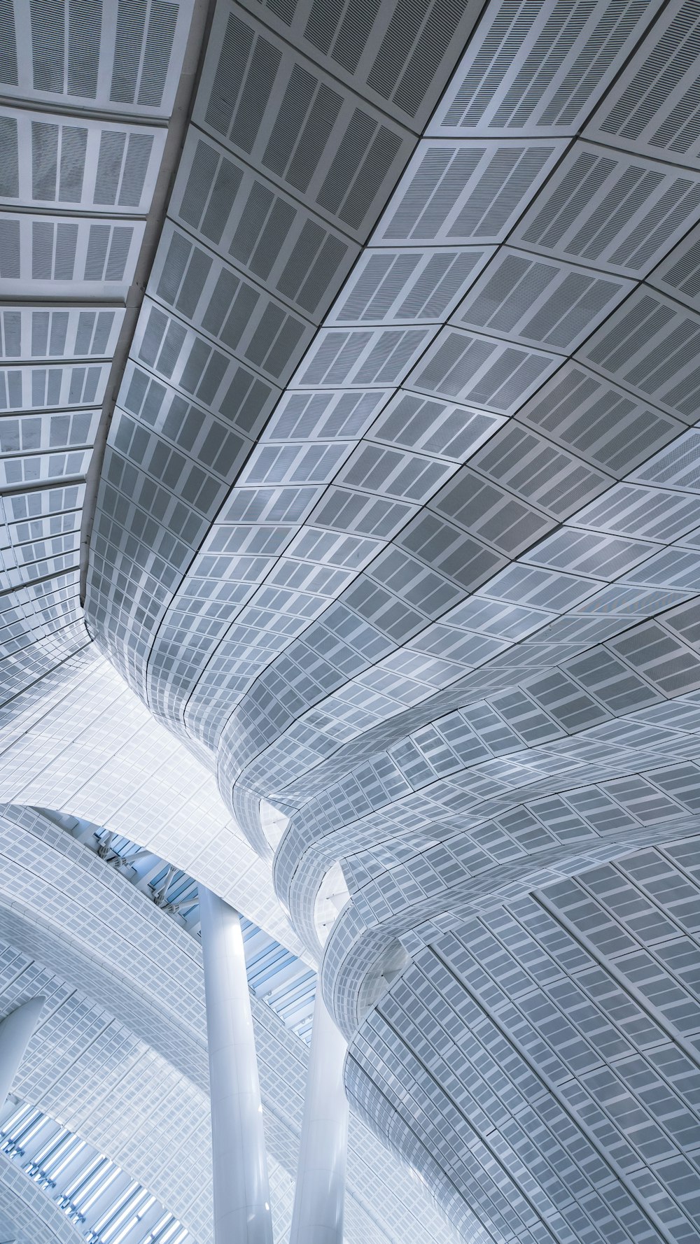 the ceiling of a large building with a clock on it