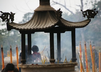 A peaceful temple setting with spiritual symbols and incense smoke.