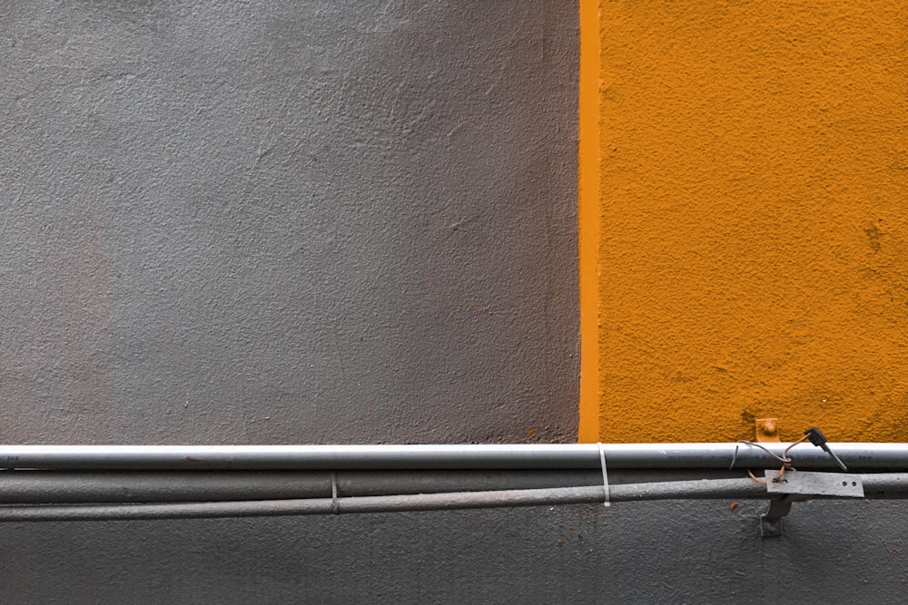 a bird is perched on the side of a building