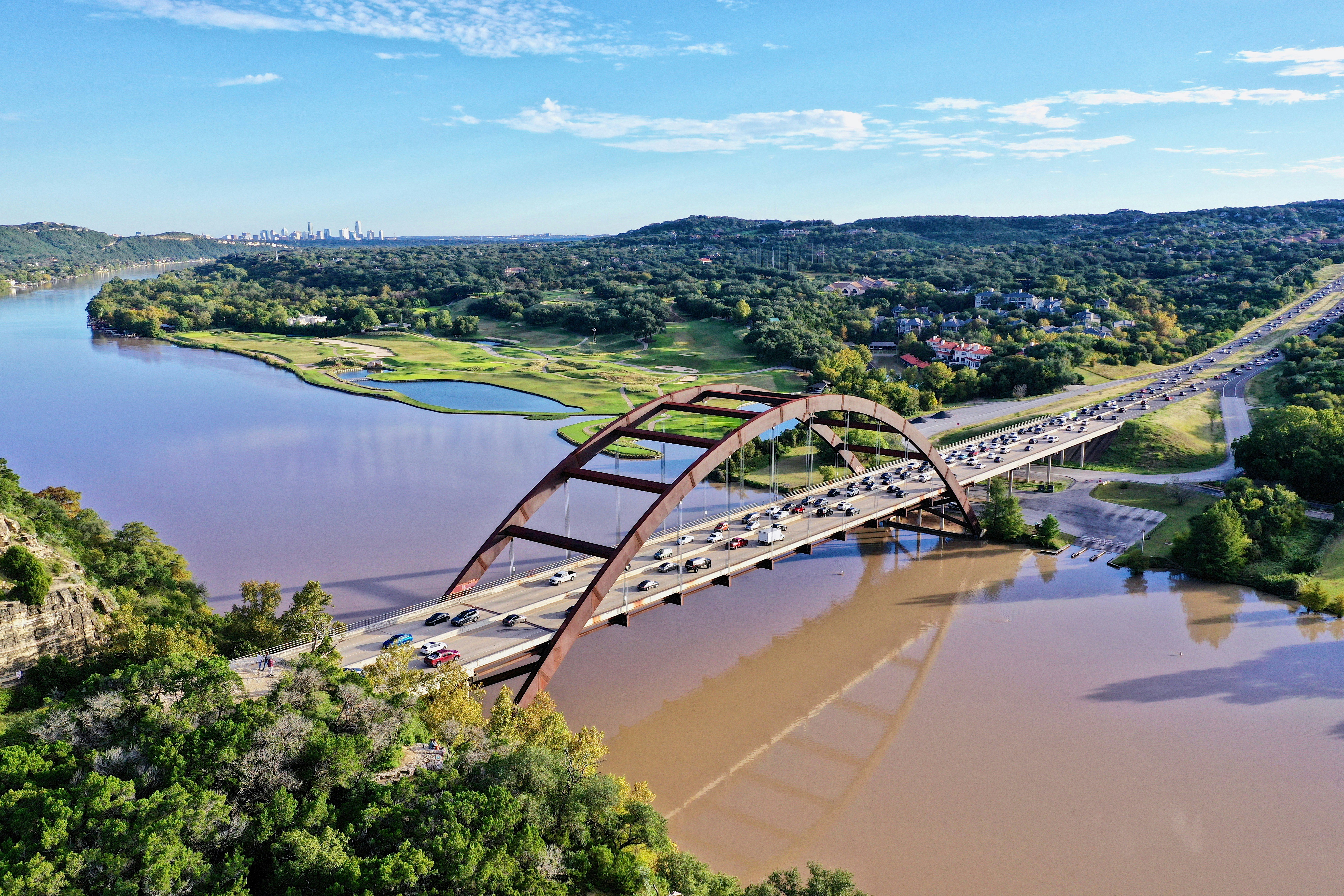 cars passing by bridge during daytime