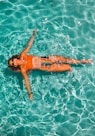 woman swimming alone in body of water