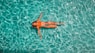 woman swimming alone in body of water