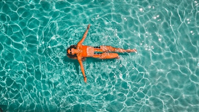 woman swimming alone in body of water