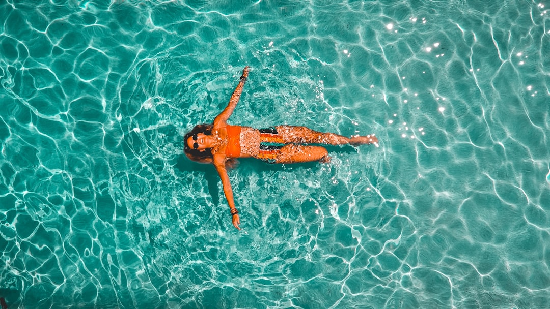 woman swimming alone in body of water,
