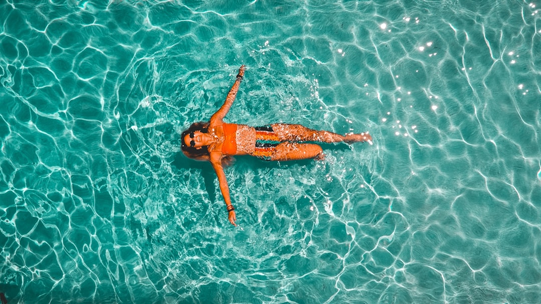 woman swimming alone in body of water