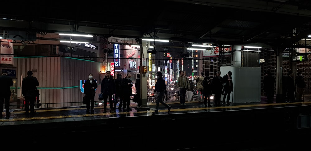 group of people standing near the road