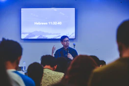 A smiling pastor speaking passionately during an online ministry session.