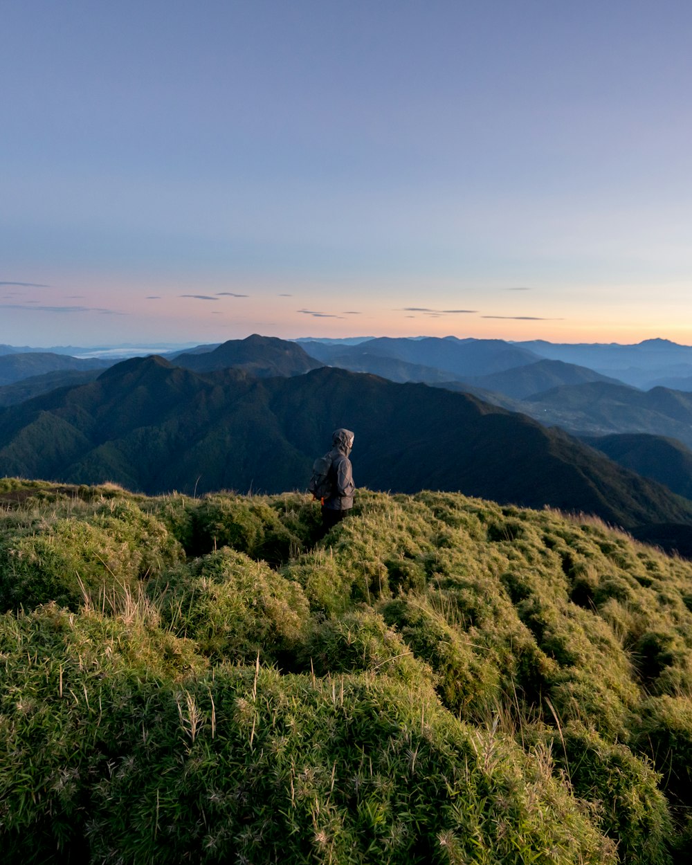 man standing on hill during daytime