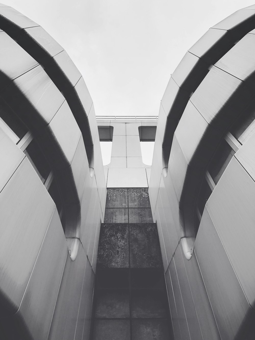 low angle and grayscale photography of building during daytime