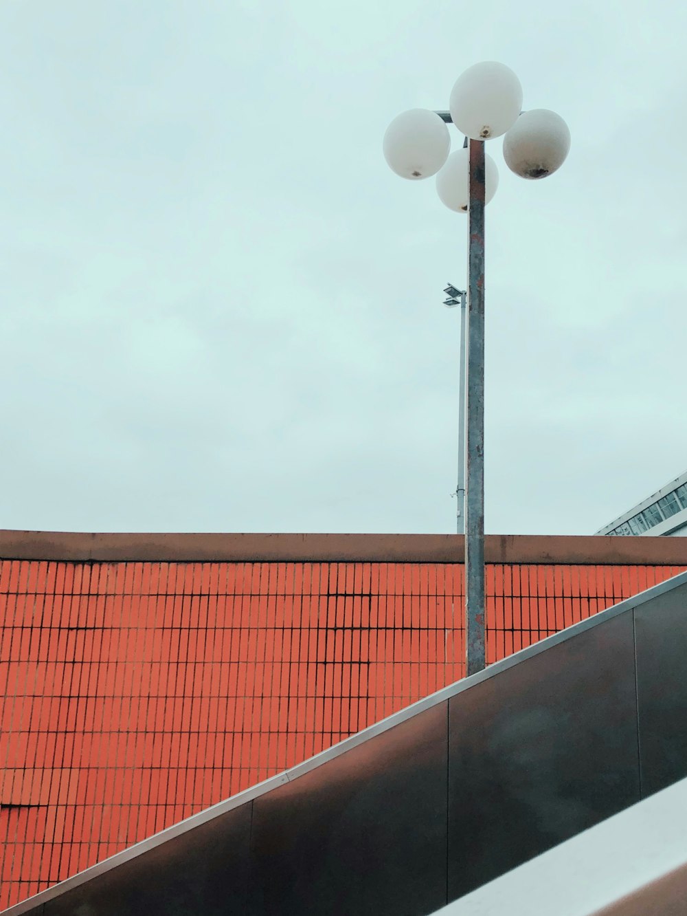 white street light near orange building during daytime