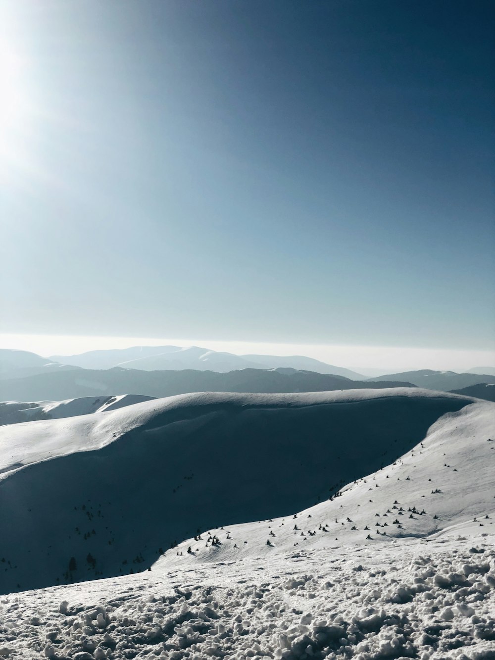 snow covered mountains under blue sky during daytime