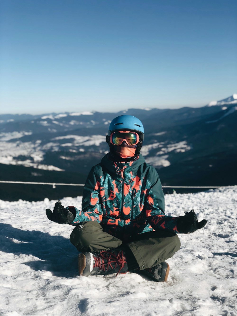 person meditating on snow field