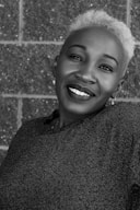 smiling woman by wall