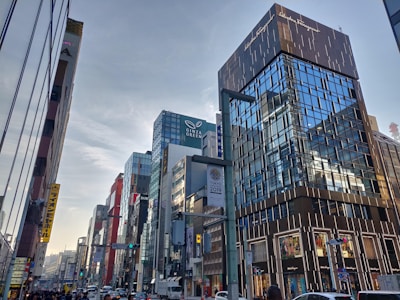 A bustling commercial building with glass facades and busy street view.