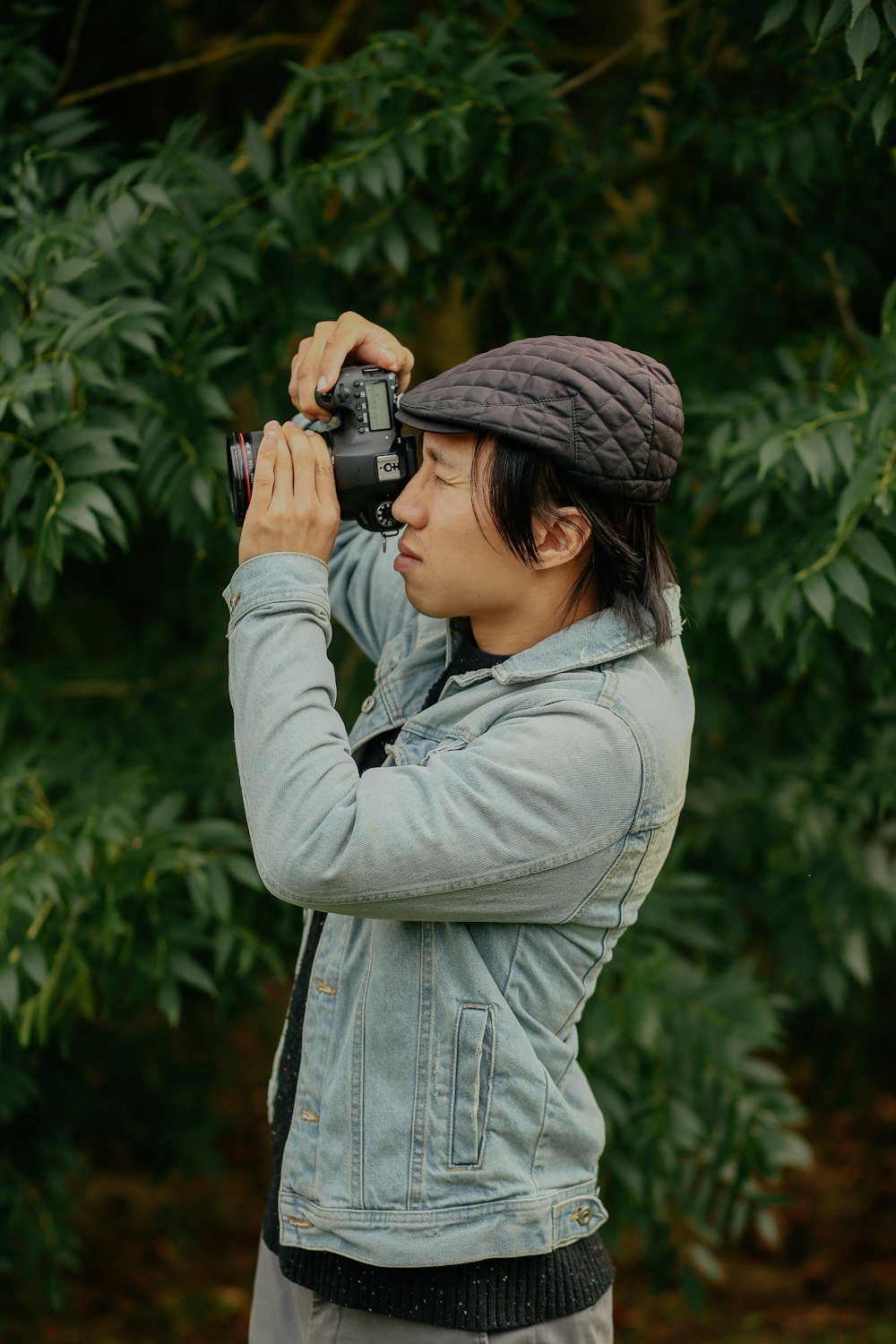 man wearing grey jacket taking picture