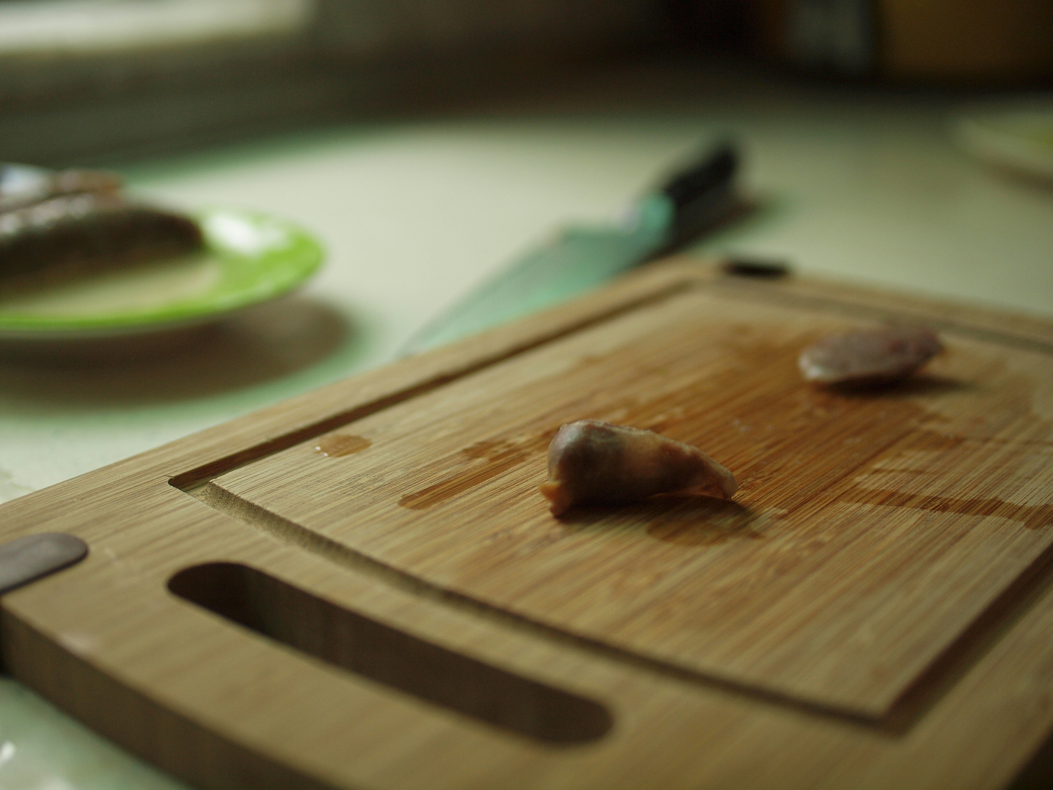 Fresh cut chicken pieces on a clean white cutting board, bright kitchen lighting