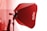 A studio light setup with a red Godox softbox attached to a lighting stand. The scene is lit with a strong red tint, likely from the lighting effect on the softbox. The backdrop is blurred, suggesting a focus on the lighting equipment.