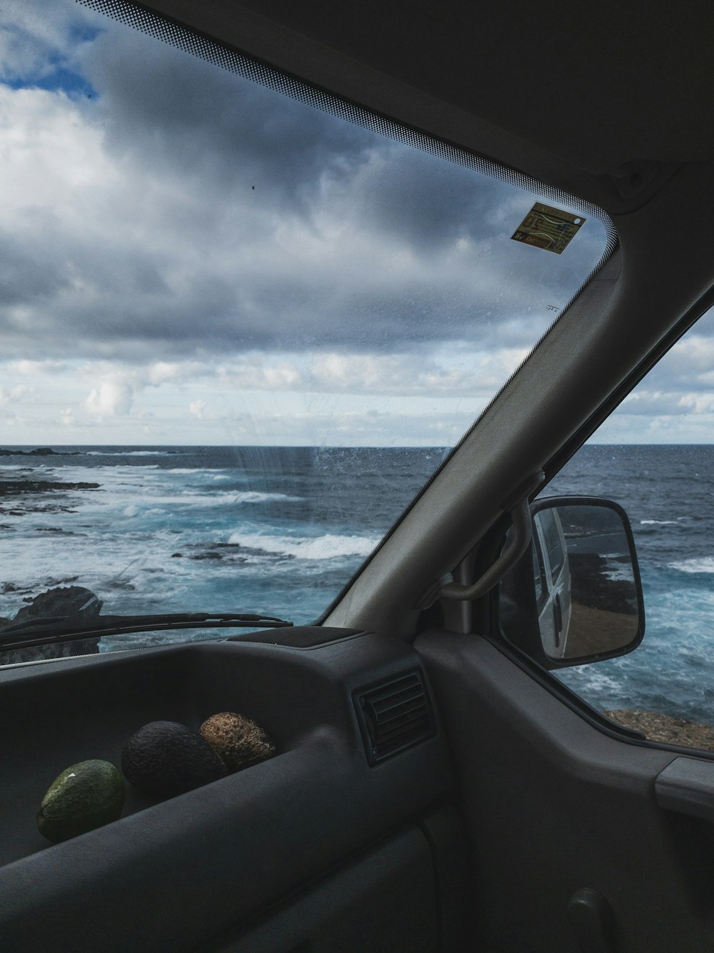 a view of the ocean from inside a vehicle
