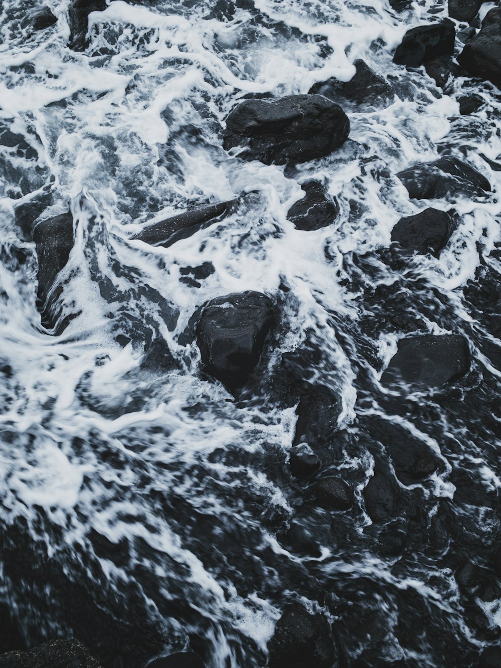flowing body of water passing through rocks