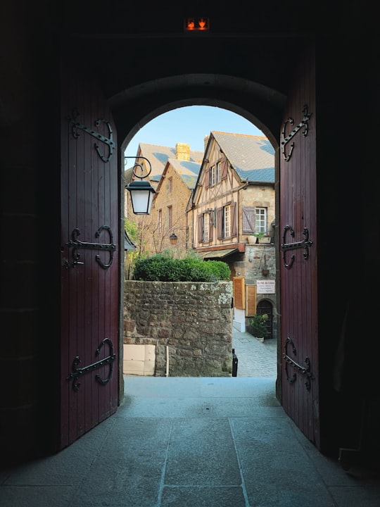 opened red wooden doors in Mont Saint-Michel France