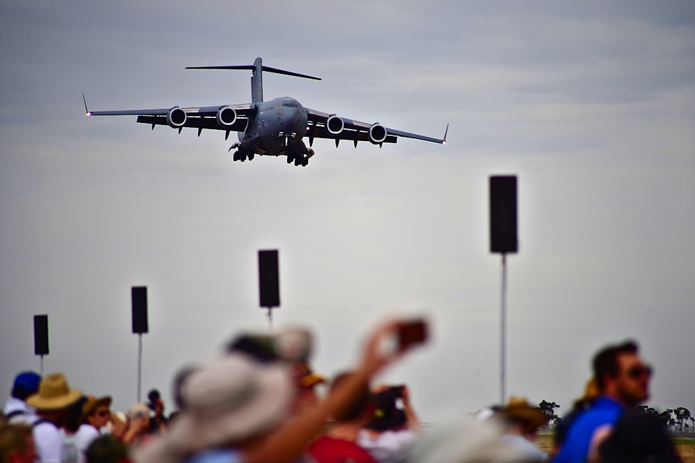 black plane above people watching