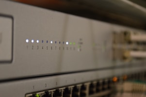 Close-up of network switches with blinking indicator lights on a modern shelf