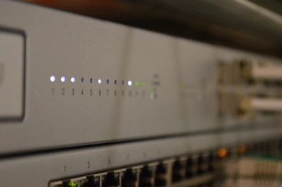 Close-up of sleek network cables plugged into a modern switch with glowing indicator lights