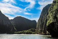 A serene view of a hidden beach cove with crystal clear water and rocky cliffs.