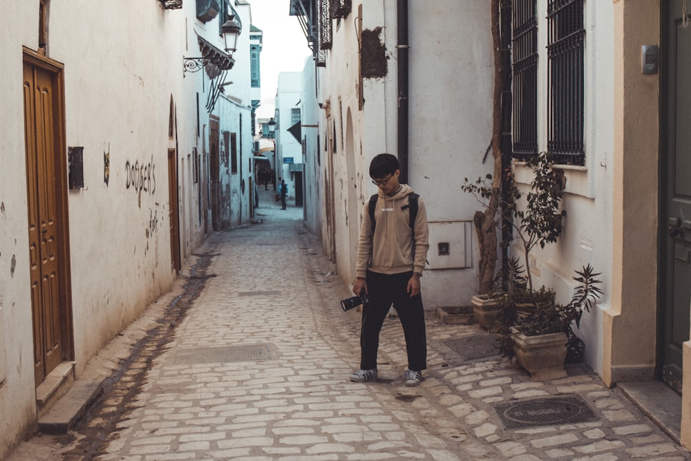 man standing on street during daytime