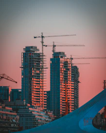 gray building crane photo during sunset