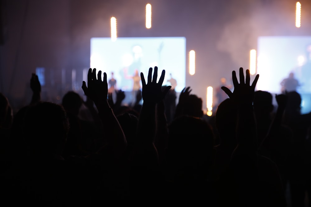 silhouette of people standing in front of stage